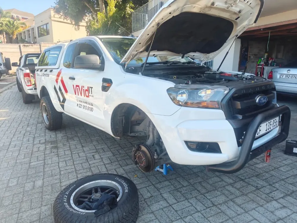 A Ford Ranger with a wheel removed